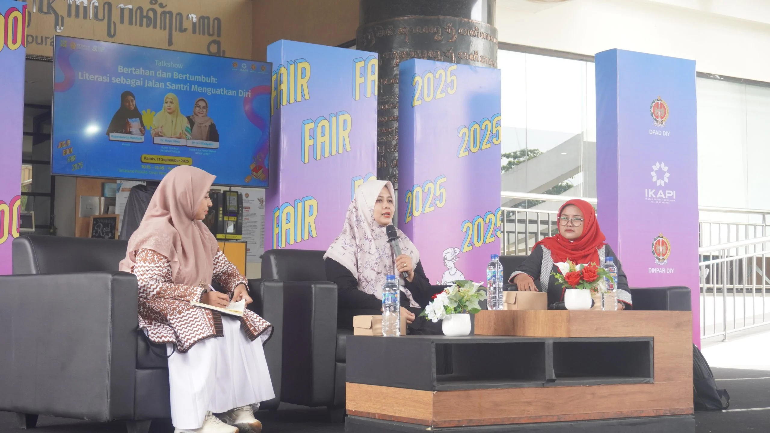 Di udara yang belum seberapa terik proses pun mulai. Seorang laki-laki melangkah pelan dari tempat parkir motor Grhatama Pustaka. Dari penampilannya orang tak akan salah menduga: sarung dan pecinya mengumumkan bahwa ia seorang santri. Pukul sepuluh pagi pada hari itu (Kamis, 11/92025), kursi-kursi yang dinaungi tenda besar telah semuanya ditempati. Santri laki-laki itu menoleh ke sana kemari. Tempat yang tersisa untuknya tinggal petak-petak kecil di sekitar bambu hias. Ia membenahi pecinya dan berdiri di sana. Gelar wicara–padanan apik untuk talk show–di panggung acara hari itu akan membahas hubungan antara santri dan literasi. Panggung itu sendiri pada hari-hari biasa adalah teras Grhatama Pustaka atau Balai Layanan Perpustakaan Dinas Perpustakaan dan Arsip Daerah DIY. *** Moderator Muyassarotul Hafidzoh memperkenalkan dua narasumber, yaitu Maya Fitria dan Sri Widayanti. Keduanya adalah dosen. Bu Maya mengajar di Departemen Psikologi UIN Sunan Kalijaga Yogyakarta dan mengasuh Pondok Pesantren Krapyak, sementara Bu Widi di STPMD APMD DIY. Moderator memulai dengan mengajukan pertanyaan tentang cara memunculkan potensi santri, juga cara menggairahkan literasi di pesantren agar santri mampu mengembangkan potensi itu dan meningkatkan kepercayaan diri. Bu Maya menanggapi dengan menceritakan program sorogan buku di pesantren yang diampunya. Program ini mengadopsi metode belajar di pesantren yang berupa sorogan kitab. Sorogan kitab adalah proses membaca kitab kuning atau kitab turot di depan seorang guru yang disertai penyampaian makna. Santri dipersilakan memilih buku apa yang akan dibaca dan kemudian menyampaikan interpretasinya kepada guru. Bu Maya juga mencermati kondisi masyarakat terkini. Ia menyebut generasi saat ini sebagai scrolling generation. Scrolling generation ini cukup mengkhawatirkan. Sebab, aktivitas scrolling adalah aktivitas yang melulu menerima informasi, tetapi tidak melakukan komunikasi. Akibatnya, seseorang akan sulit mengendalikan emosi ketika berhadapan dengan orang lain atau kenyataan. Selain itu, aktivitas scrolling yang dilakukan terus-menerus akan menghilangkan kepekaan. Padahal, kepekaan terhadap diri sendiri dan kepekaan terhadap orang lain adalah tahap awal dari kesehatan mental. Solusi untuk masalah tersebut, menurut Bu Maya, adalah delay scrolling. Delay scrolling bisa berupa aktivitas membaca buku maupun aktivitas mengobrol. Dengan membaca, seseorang bisa memiliki kemampuan rasio, perencanaan, dan berpikir kritis. Dari keterangan Bu Maya, moderator menyimpulkan bahwa pikiran kita harus dirawat agar tidak dikuasai oleh emosi. Sebab, emosi hanya akan membuat daya nalar tidak berfungsi sehingga kesehatan mental terganggu dan kepercayaan diri bisa lenyap. Bu Widi membuka pembicaraan dengan membedah arti literasi. Menurutnya, literasi pada awalnya memang berarti huruf, tetapi kemudian dimaknai sebagai membaca dan menulis. Kedua kegiatan itu membutuhkan kemampuan memaknai yang dalam dunia santri diasah melalui ngaji sorogan. Selain itu, dibutuhkan pula kemampuan kritis yang di kalangan santri dilakukan melalui kegiatan bahtsul masail yang dikaitkan dengan aktivitas dialektika. Membaca dan menulis bukan hanya berkaitan dengan melek huruf, tetapi juga melek konteks sehingga keduanya dapat berdialektika agar hasil pemaknaan tidak sempit. Bu Widi melanjutkan dengan menjelaskan empat aspek belajar, yaitu nilai, nalar, moral, dan norma. Nilai adalah sesuatu yang abstrak dan diyakini kebenaranya. Misalnya nilai kemanusiaan. Membaca dan menulis akan memperlihatkan kecenderungan (keberpihakan) individu pada nilai tertentu. Nalar adalah logika atau cara berpikir. Ketika seseorang sudah meyakini kebenaran dari nilai kemanusiaan, logikanya akan bekerja. Setiap produk tulisan dan analisis bacaannya akan ditujukan pada nilai tersebut. Moral adalah sebagai kebenaran yang menjadi modal refleksi diri, sementara norma adalah hukum yang akan menjadi landasan untuk bagaimana seseorang bersikap atau bertindak. Nilai dan nalar membentuk cara berpikir dan moral dan norma membentuk cara bertindak. Dengan demikian, literasi bukan hanya melulu tentang membaca dan menulis untuk memproduksi pengetahuan atau sekadar aktivitas intelektual. Literasi juga merupakan aktivitas spiritual dan moral yang bisa dipertanggungjawabkan secara hukum, baik di dunia maupun di akhirat. Bu Widi menyimpulkan paparannya dengan menyatakan bahwa literasi santri dalam tradisi pesantren membentuk cara berpikir, cara bertindak, keberanian untuk kritis, dan berani berjuang bagi kemanusiaan. Teori dari kitab-kitab klasik sangat relevan untuk dimaknai sesuai kondisi terkini. Maka, dialektika dengan realitas bakal membentuk pemahaman yang luas dan mendalam bagi santri dan membentuk positioning atau keberpihakan. Demikianlah literasi membentuk keberanian berpikir dan bersikap. Ini pula yang menjawab pertanyaan tentang bagaimana santri bisa lebih percaya diri ketika berbaur dengan masyarakat akademik. Karena, ilmu yang diajarkan di pesantren adalah ’ilmu amaliyah dan ‘amal yang ‘ilmiyah. *** Santri laki-laki itu telah mengikuti gelar wicara dengan setia. Ia tetap di depan panggung, terlindung di bawah teduhan bambu hias, hingga tiga pertanyaan dari peserta tuntas dijawab. Ia baru beranjak setelah moderator menutup acara secara resmi. Berbeda dari saat ia datang tadi, ini kali ayunan kakinya lebih cepat ketika ia melangkah ke tempat parkir. Matahari memang sudah tepat di atas kepala, sementara langit membiru tanpa awan.***